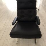 Grained leather armchair with rocking movement