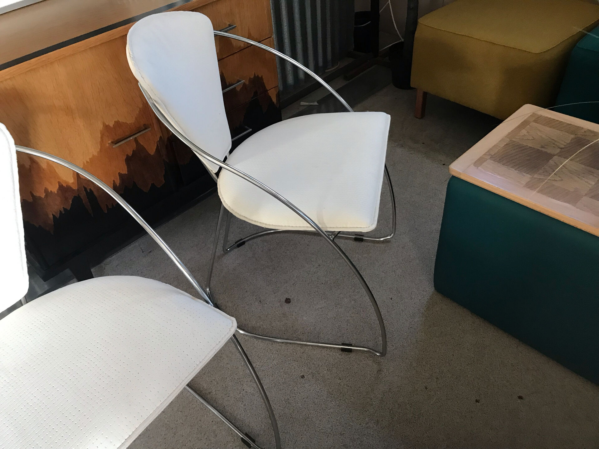 Set of two design chairs in steel and faux leather.