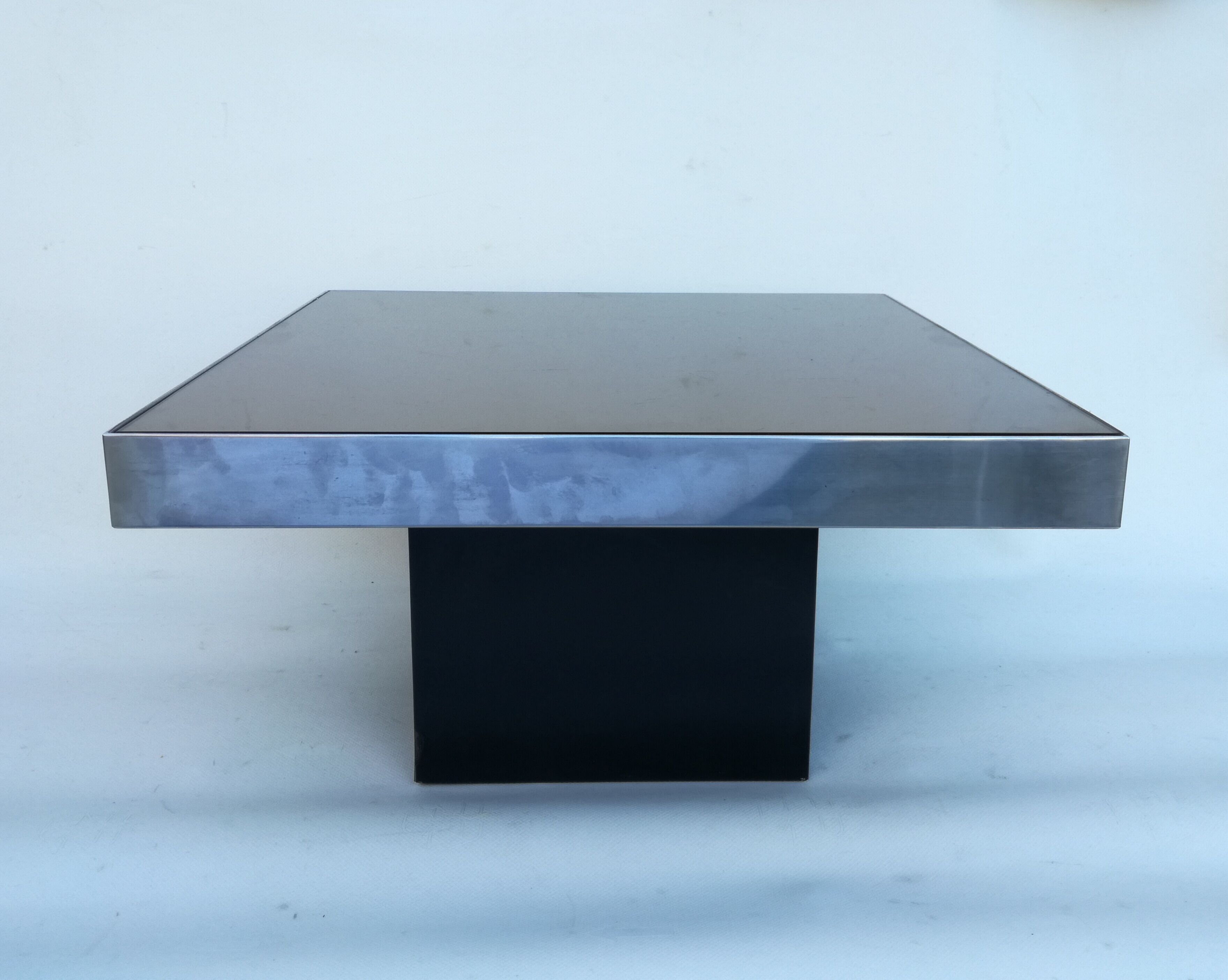 Square pedestal coffee table with mirror top