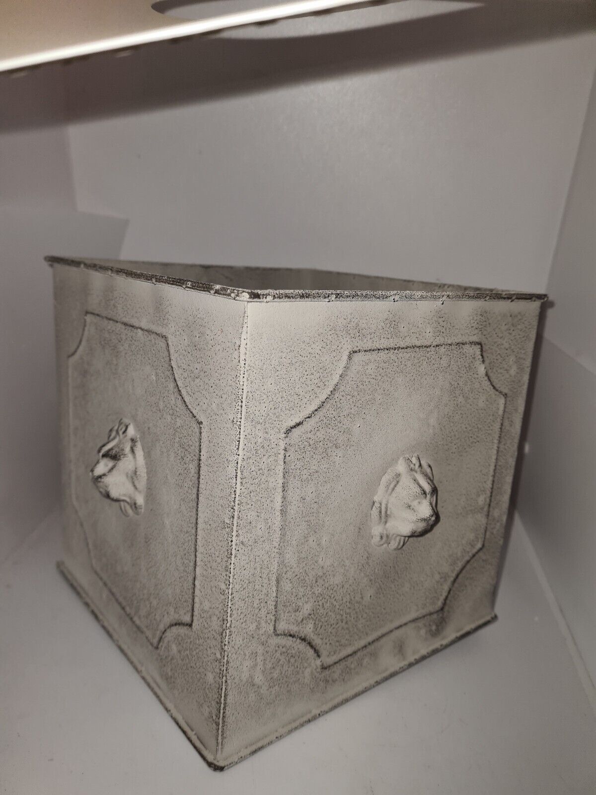 Square planter with a patinated iron lion's head