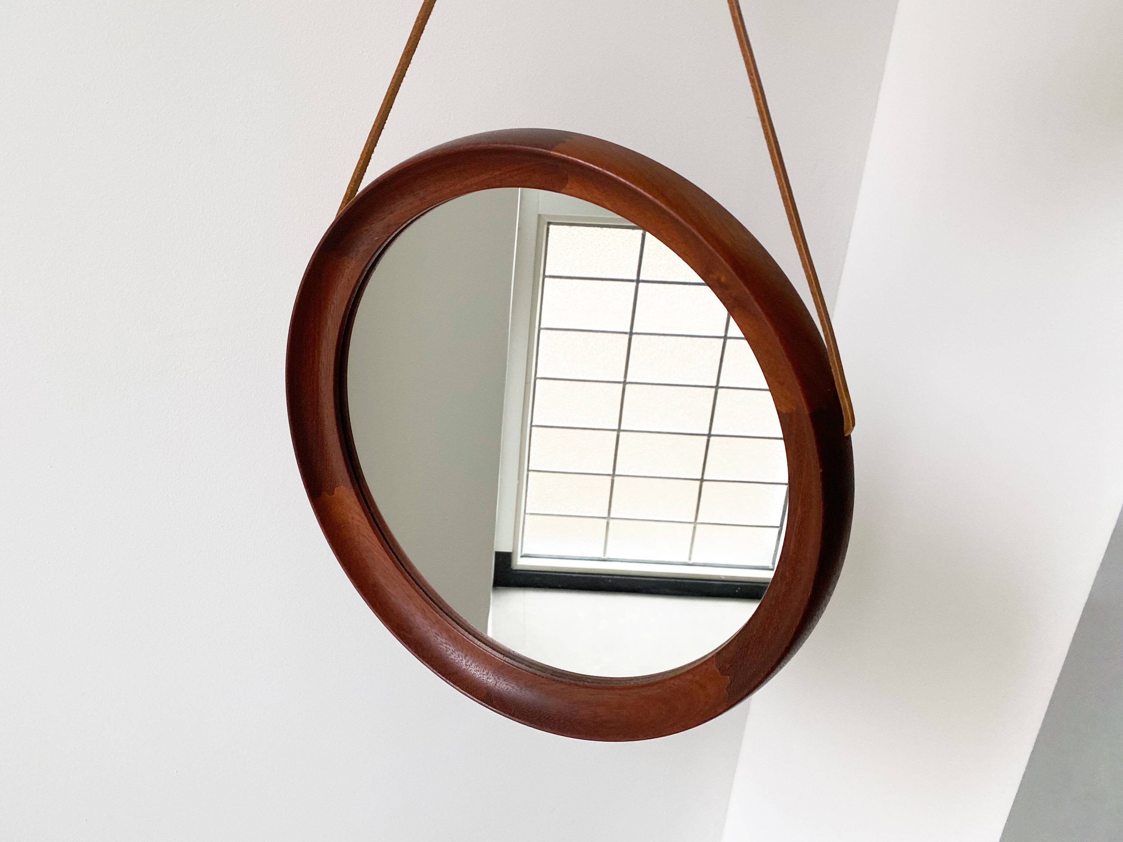Mid Century solid teak wall mirror with a leather strap - Danish design