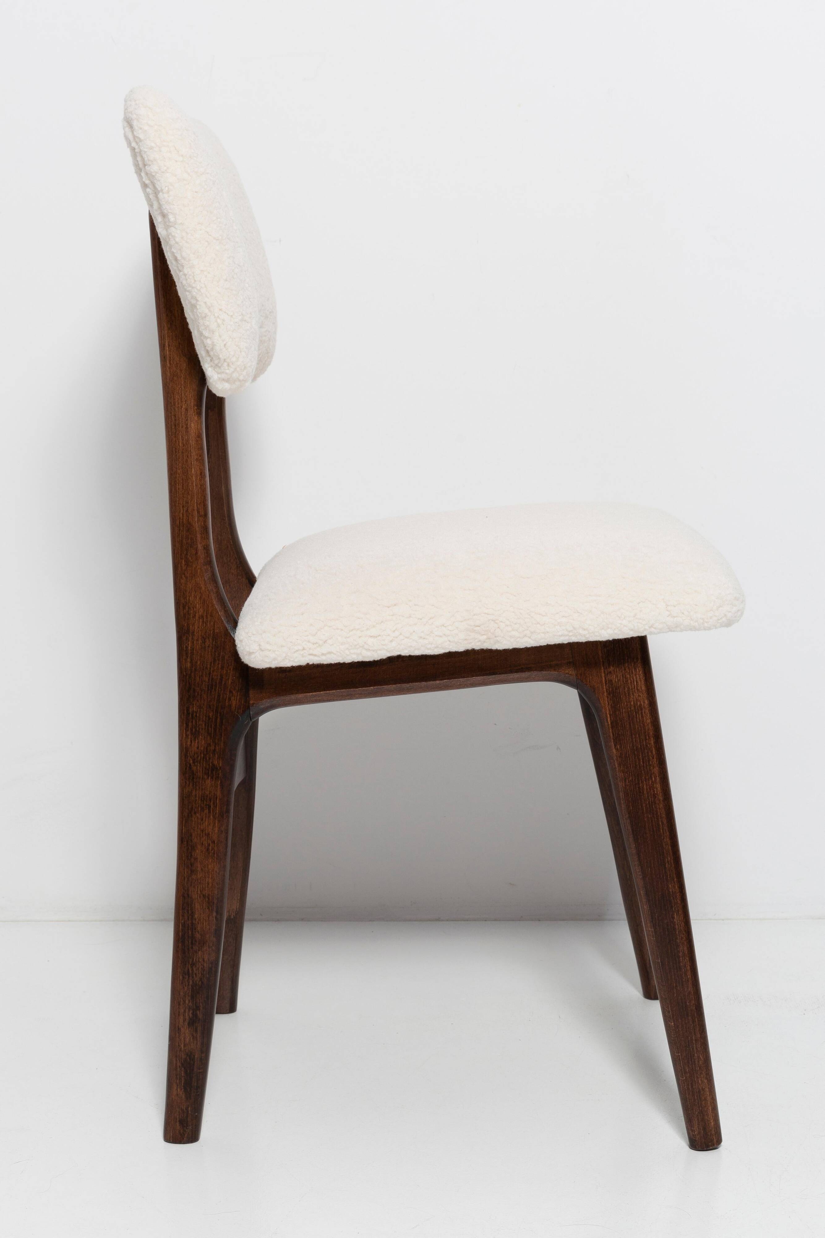 20th-century walnut and light cream boucle butterfly chair, Europe, 1960.