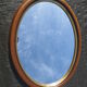 Old oval mirror, walnut wood tower, gilded border