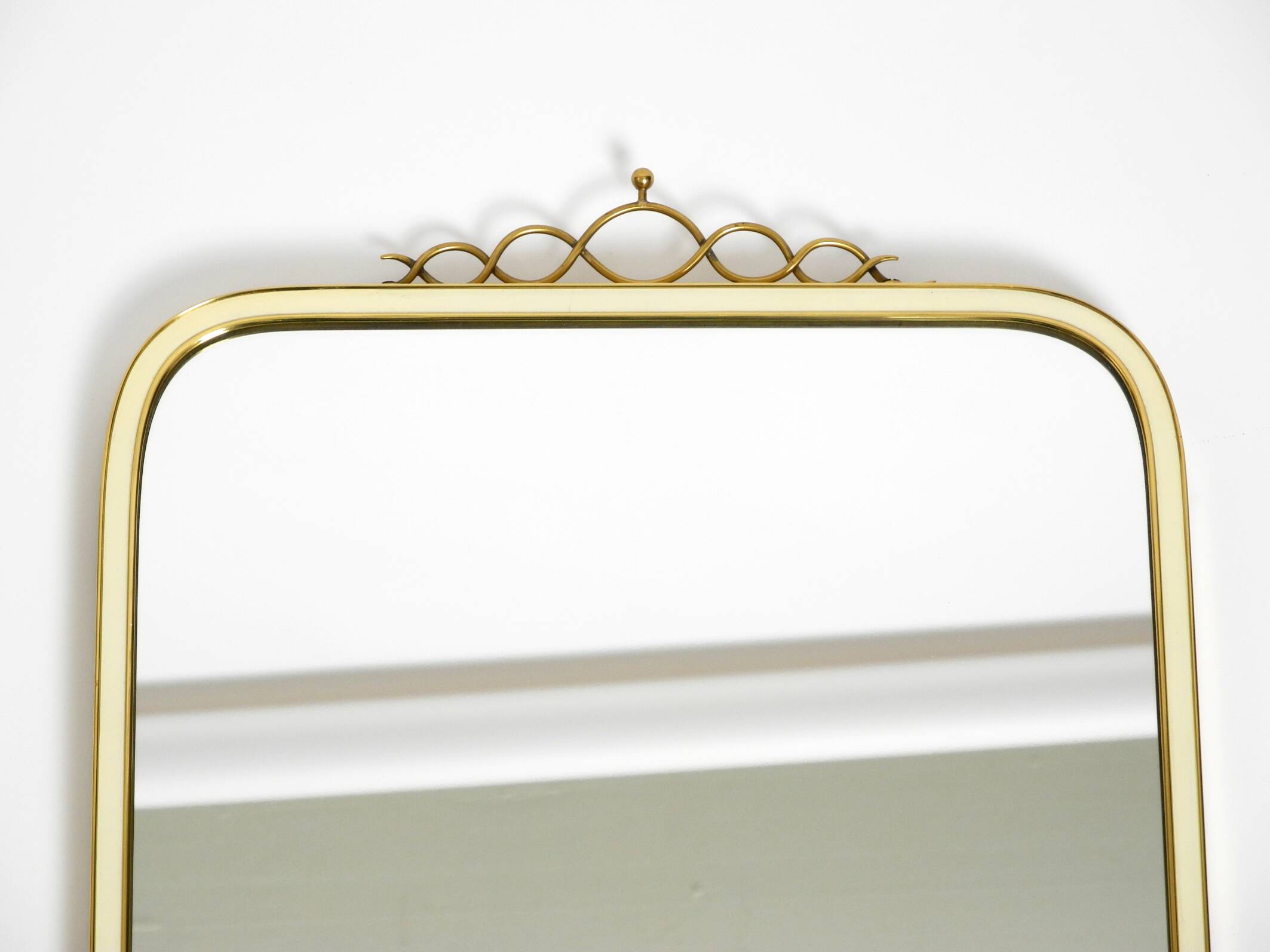 Large heavy long Mid Century brass wall mirror by Münchner Zierspiegel