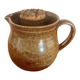 Large antique brown glazed stoneware jug with cork stopper.