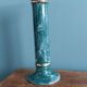 Column candle holder in ceramic with green and gold marble effect.