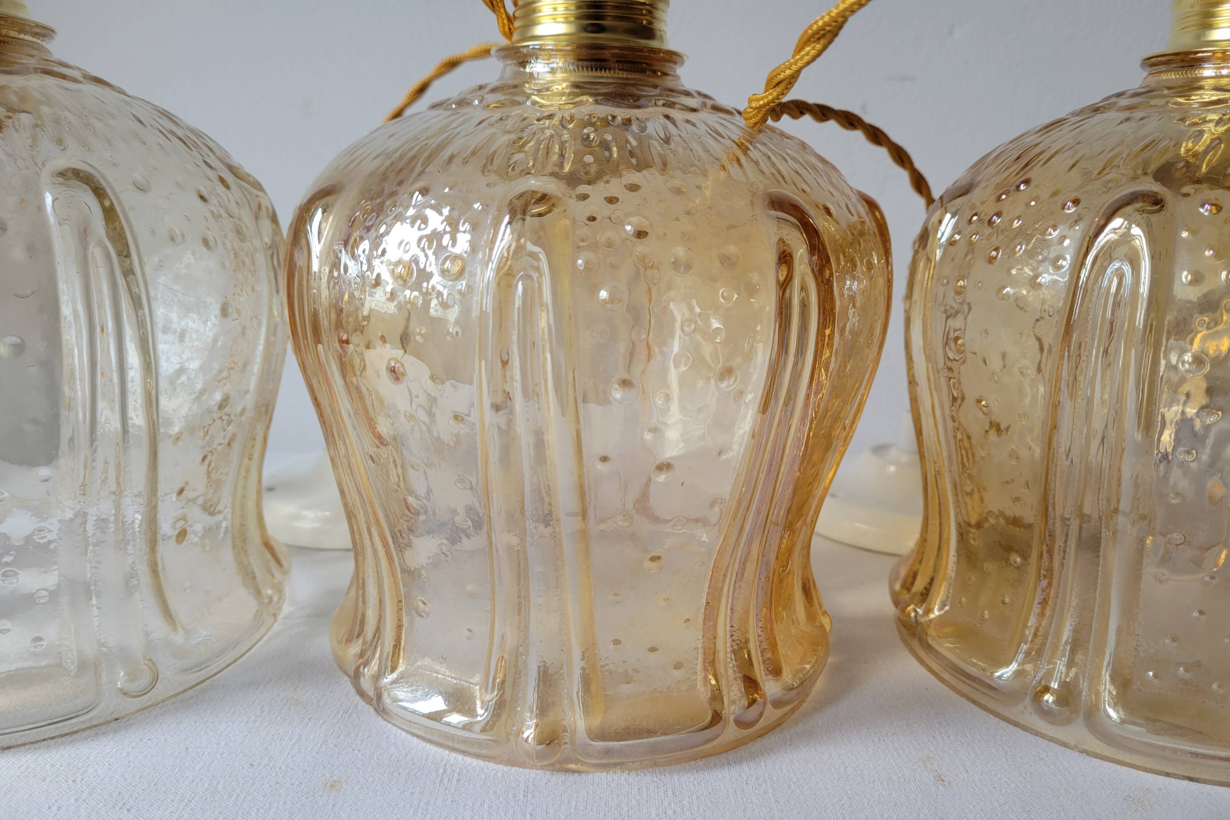 Trio of amber glass pendant lights
