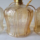 Trio of amber glass pendant lights