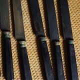 A set of 8 knives with black wooden handles