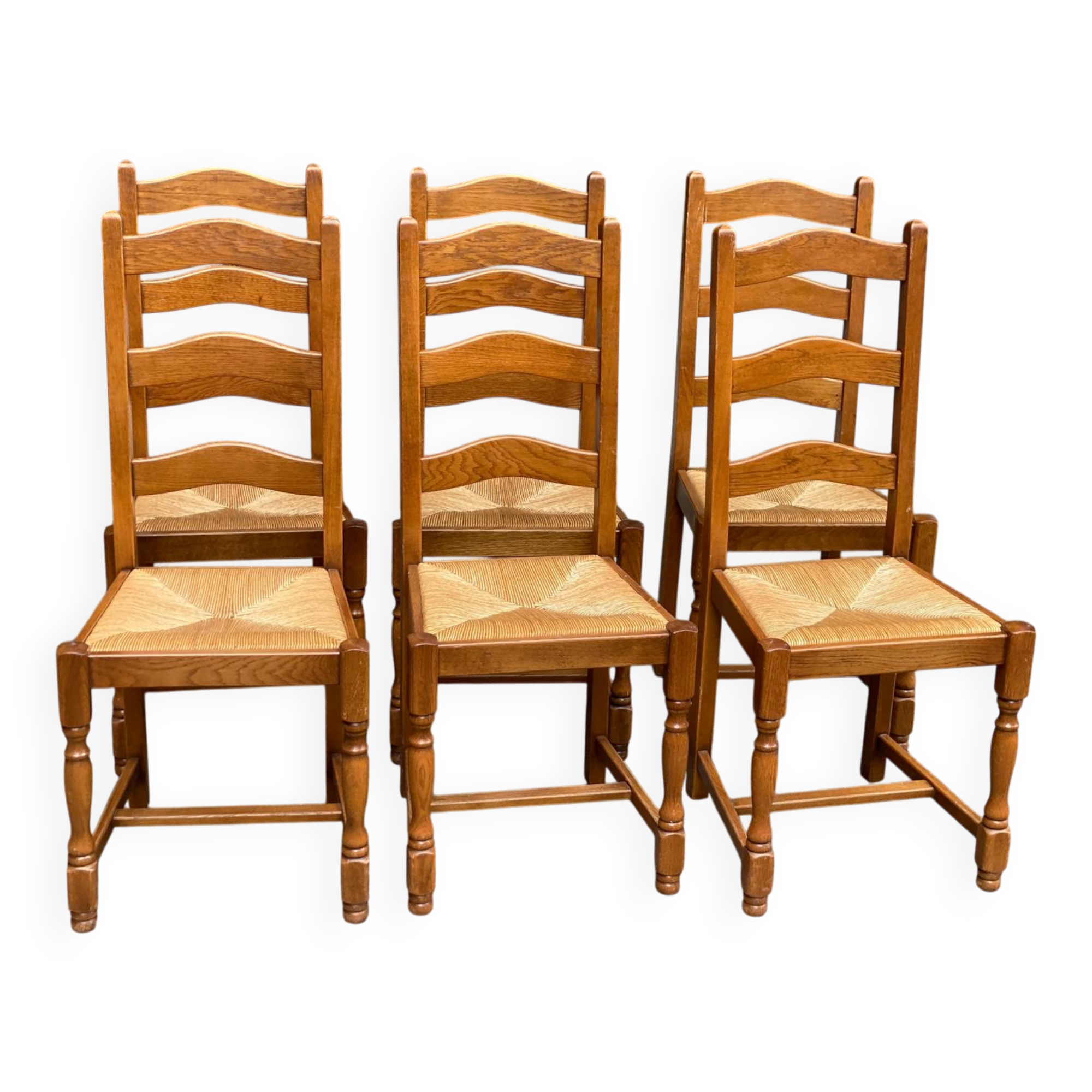 6 solid oak dining chairs with rush seats from the 1980s.