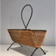 Rattan and black lacquered metal magazine rack
