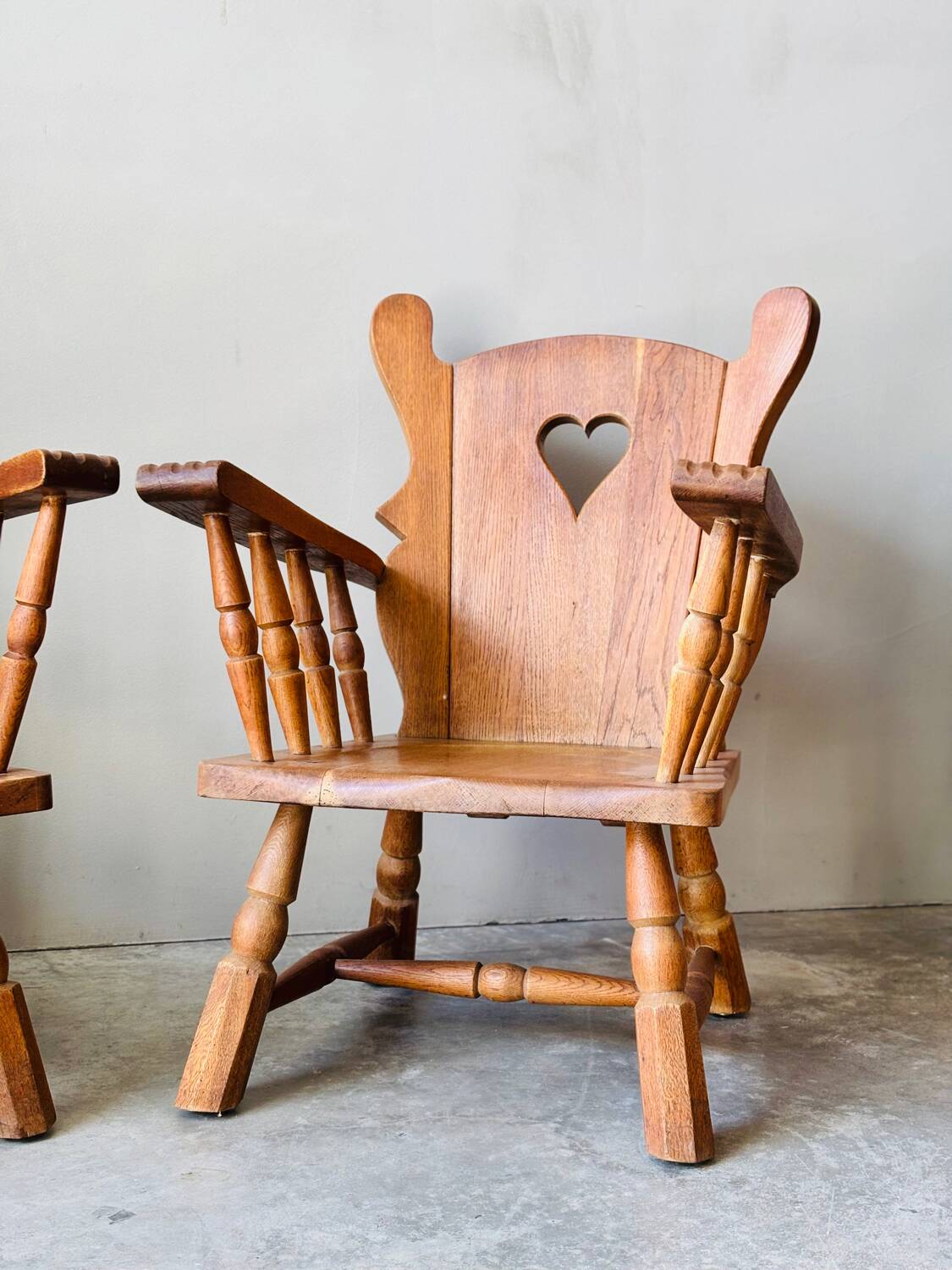 Pair of rustic oak armchairs – carved heart backrests