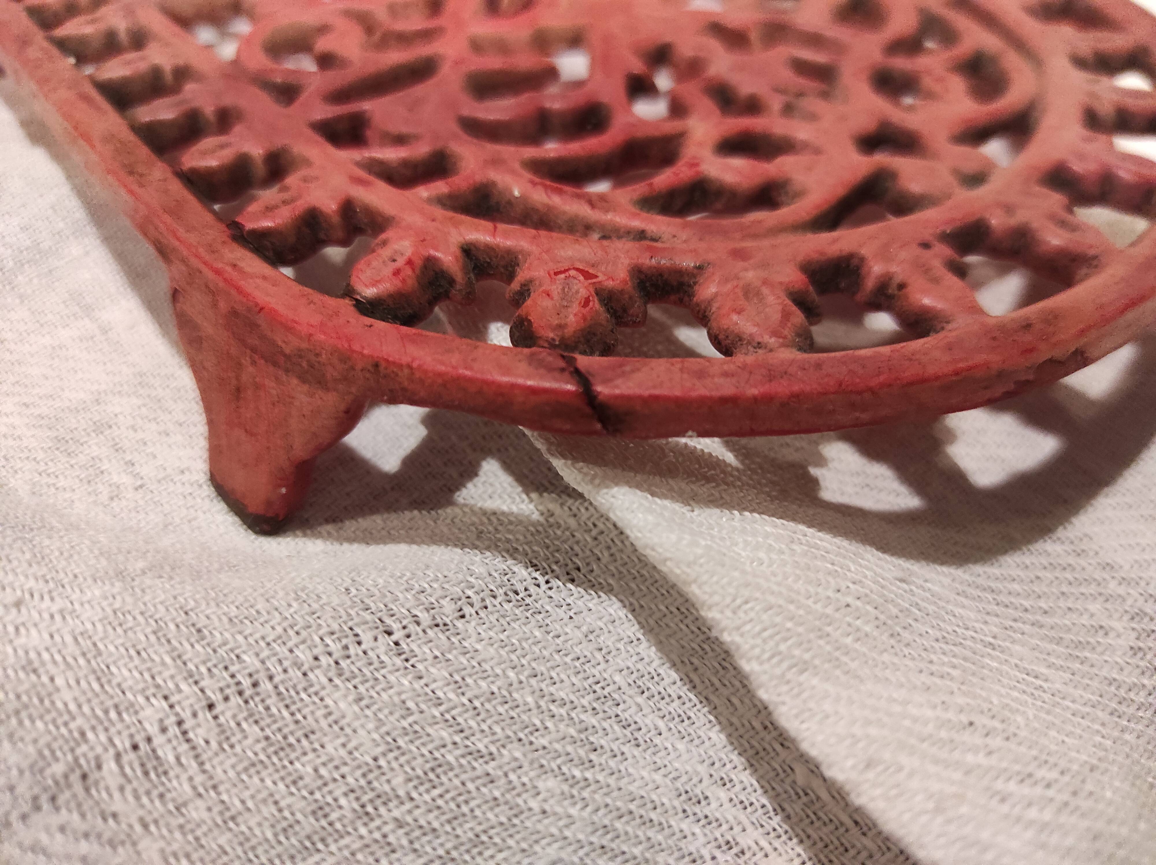 Vintage oval dark coral pink cast iron trivet