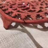 Vintage oval dark coral pink cast iron trivet