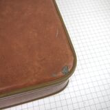 Cardboard and brown leather case