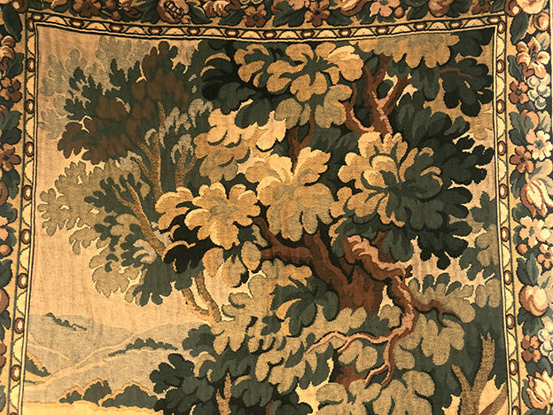 Tapestry decorated with a pink flamingo in a green landscape, woven by hand