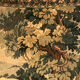 Tapestry decorated with a pink flamingo in a green landscape, woven by hand