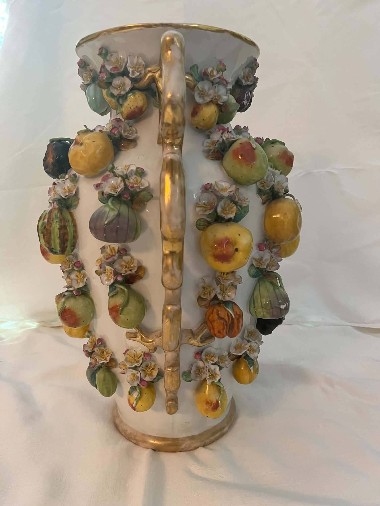 Large antique vase with relief decorations of coloured fruits.