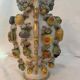 Large antique vase with relief decorations of coloured fruits.