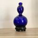 Vase opaline bleue, socle bois