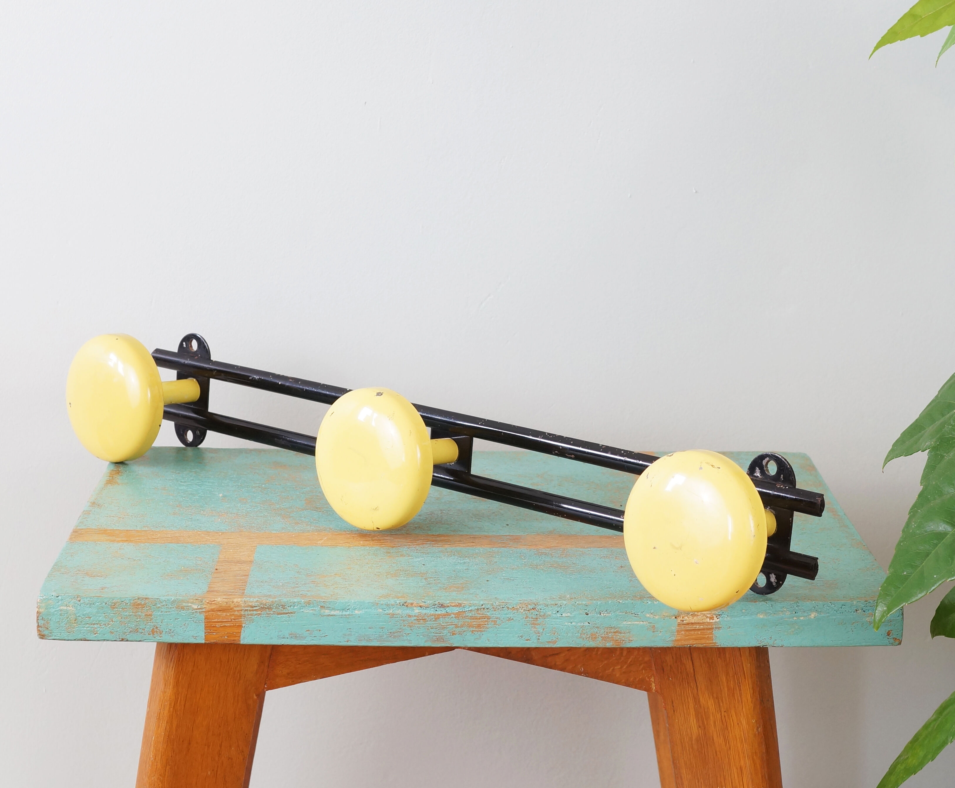 Yellow and black enamelled metal hook, 60s