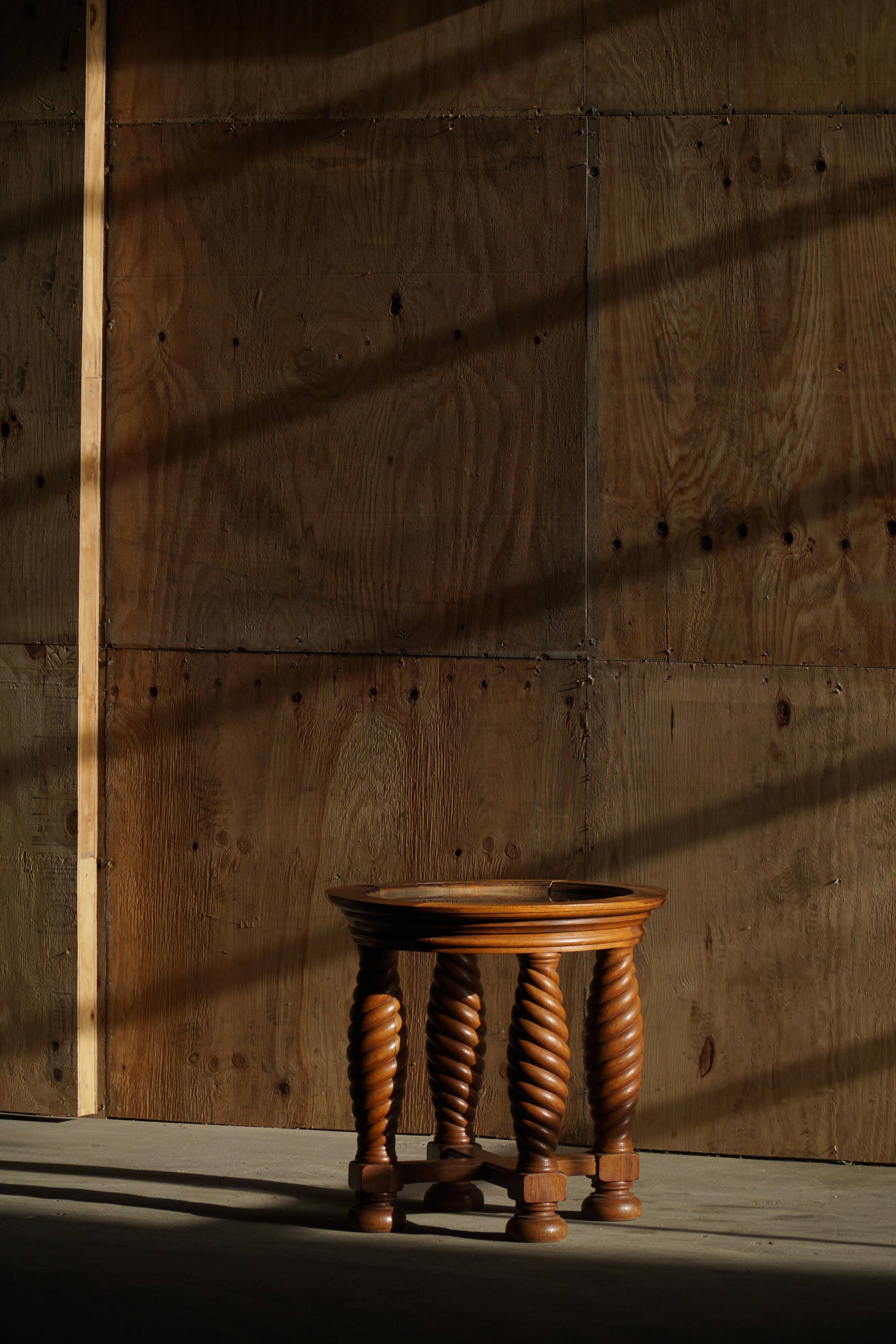 Modern Danish mid-century table, made of oak with spiral turned legs and a glass top, 1950s.