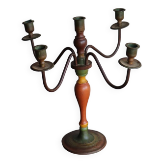 Old candlestick in painted wood and folding metal