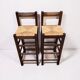 Set of 2 vintage wooden bar stools with woven straw seats.