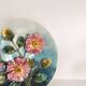 Decorative plate with relief floral pattern in majolica.