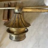 Adjustable wall light in brass and gold metal.