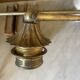 Adjustable wall light in brass and gold metal.