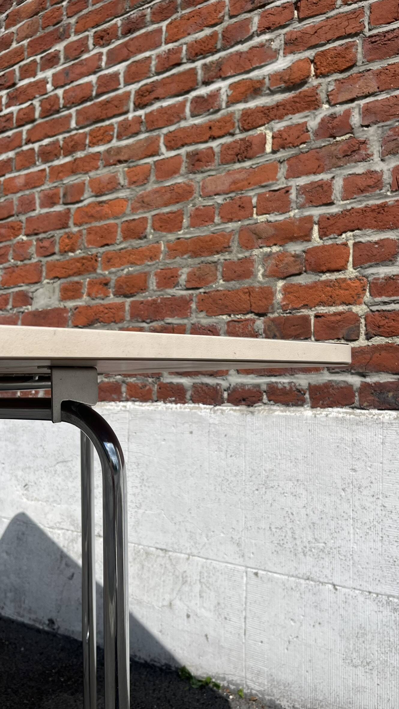 Folding table with chrome and pink formica.