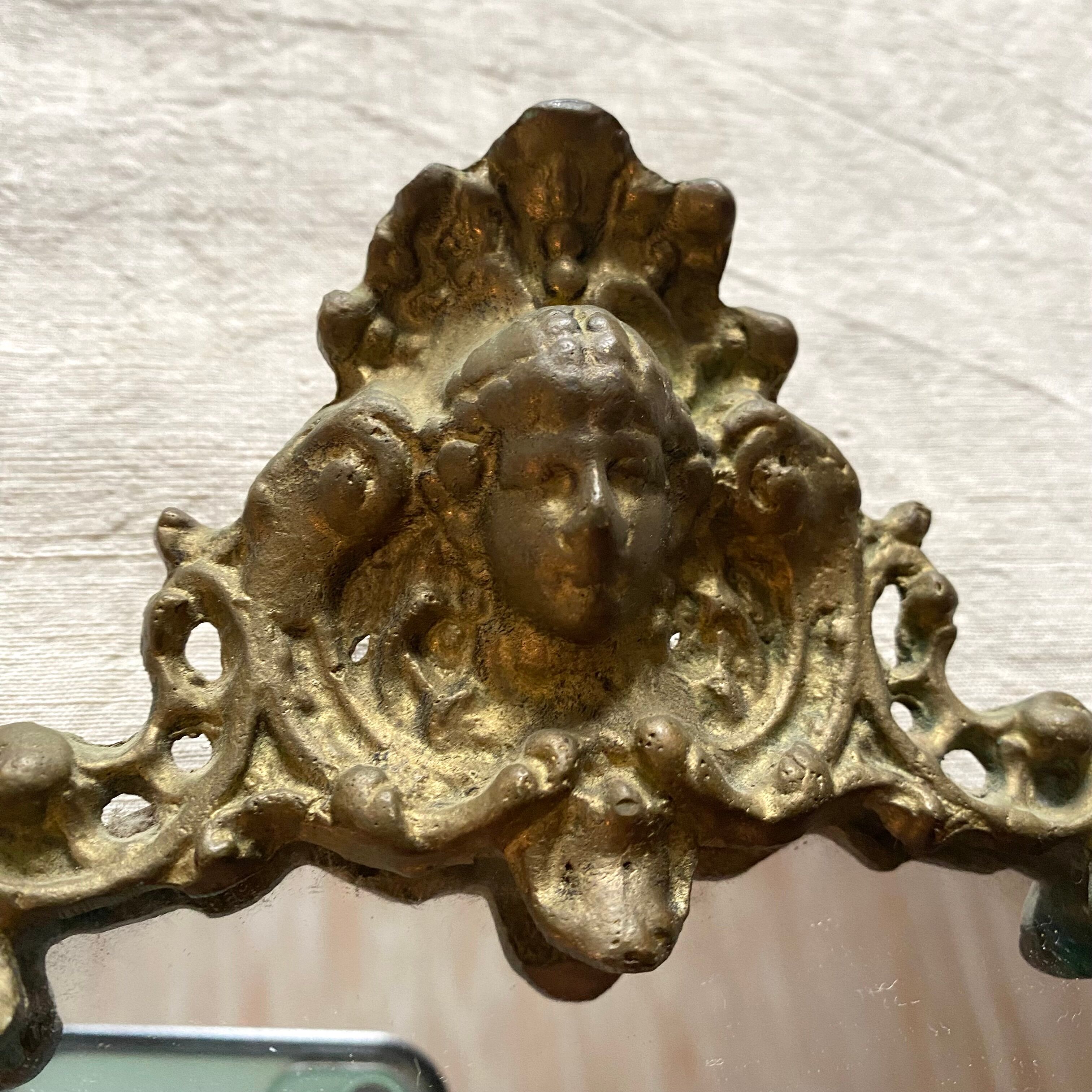 Antique oval brass crest mirror, 41x26 cm