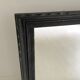 1950s mirror, matte black wood with a patina.