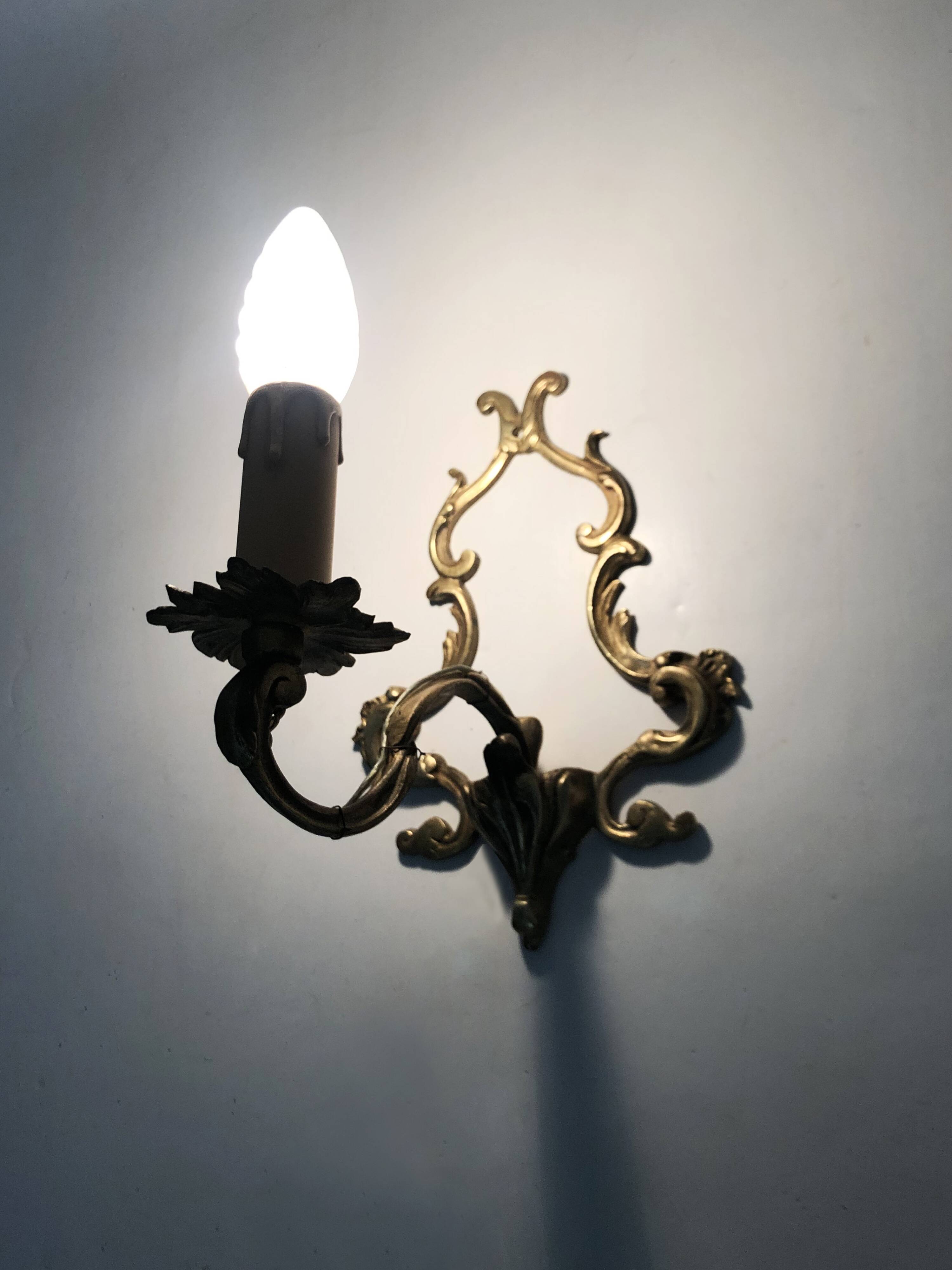 Vintage pair of bronze wall sconces from the 1950s and 60s.