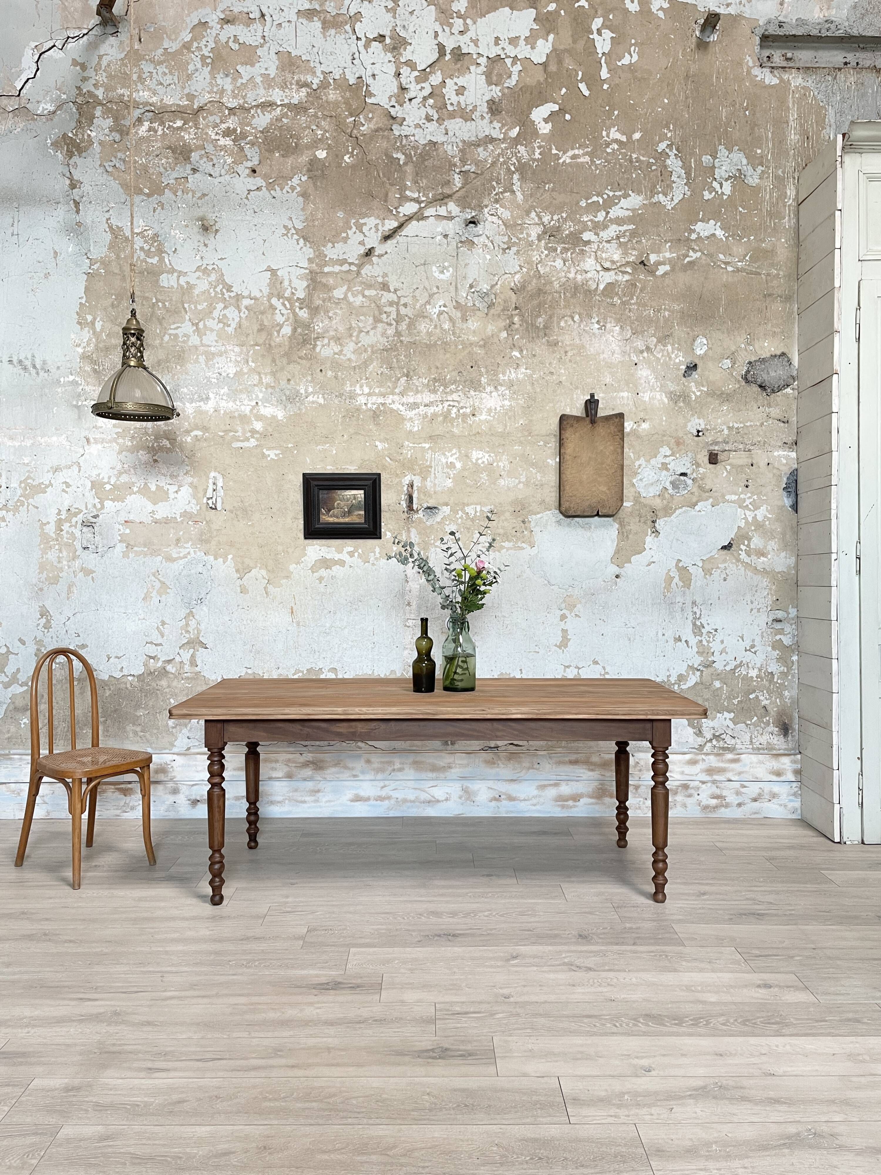 Vintage farmhouse table with turned legs.