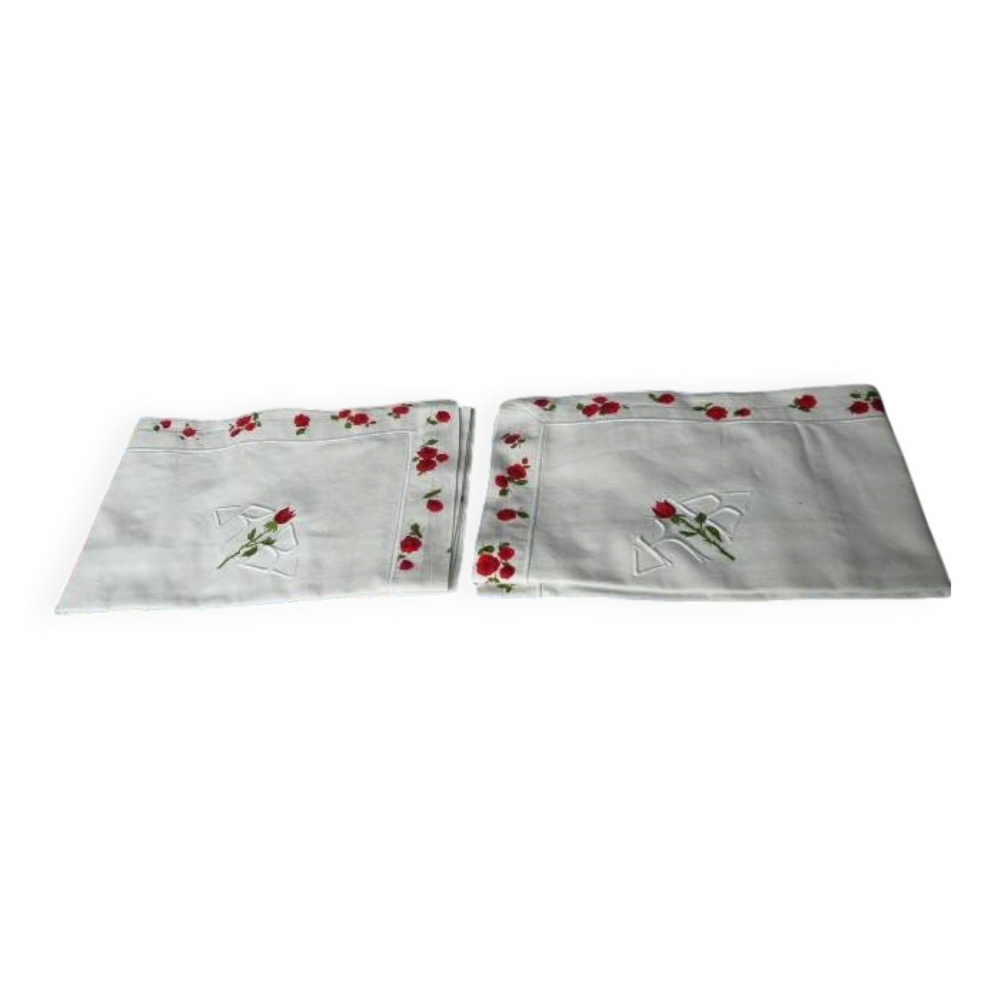 pair of monogrammed RB embroidered pillowcases in pink and red
