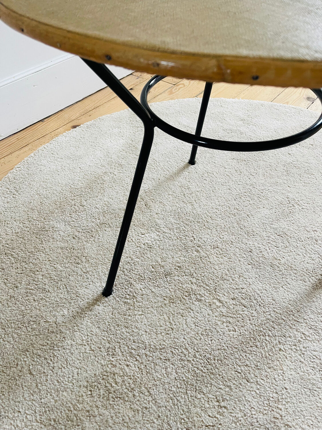 Tripod coffee table with a straw covering.
