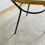 Tripod coffee table with a straw covering.