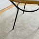 Tripod coffee table with a straw covering.