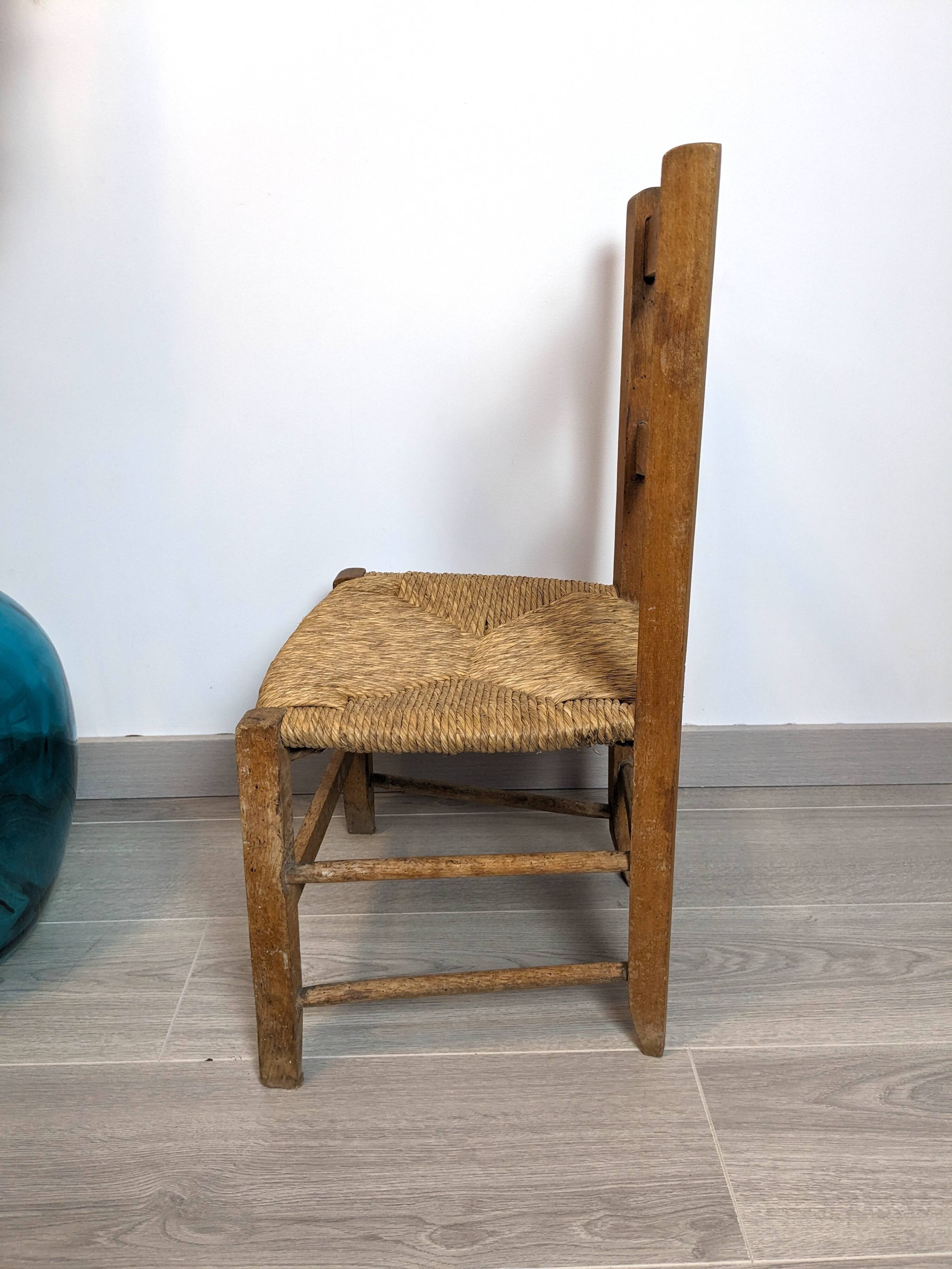 Vintage wooden and straw children's chair in a country style.