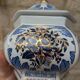Decorative pot jar with a lid featuring a blue floral pattern and gilding.