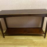 Mahogany console with a golden border.