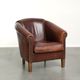 Characterful sheepskin club armchair in a dark cognac colour in English style