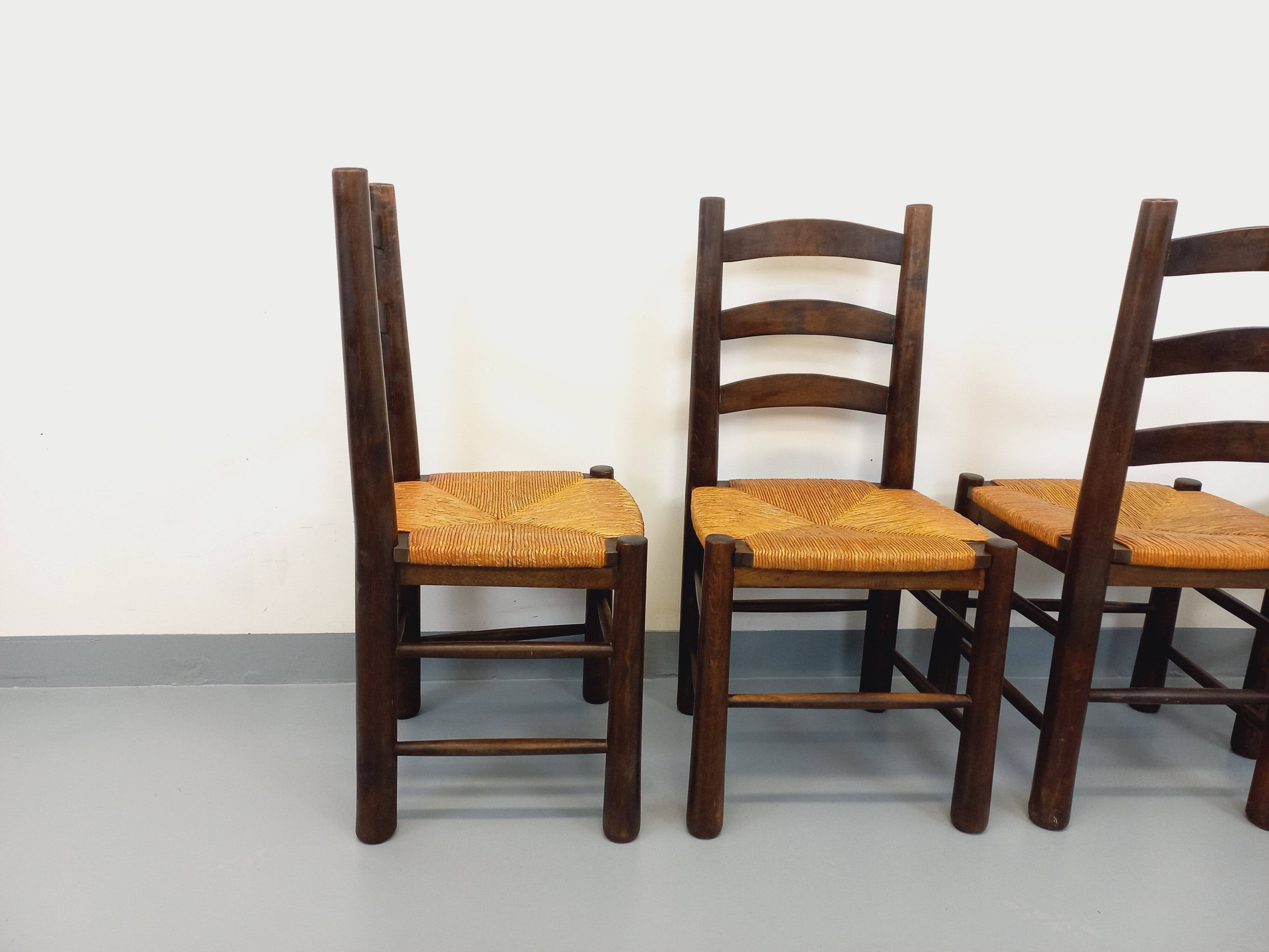 Set of 4 vintage brutalist chairs by Georges Robert in wood and straw.