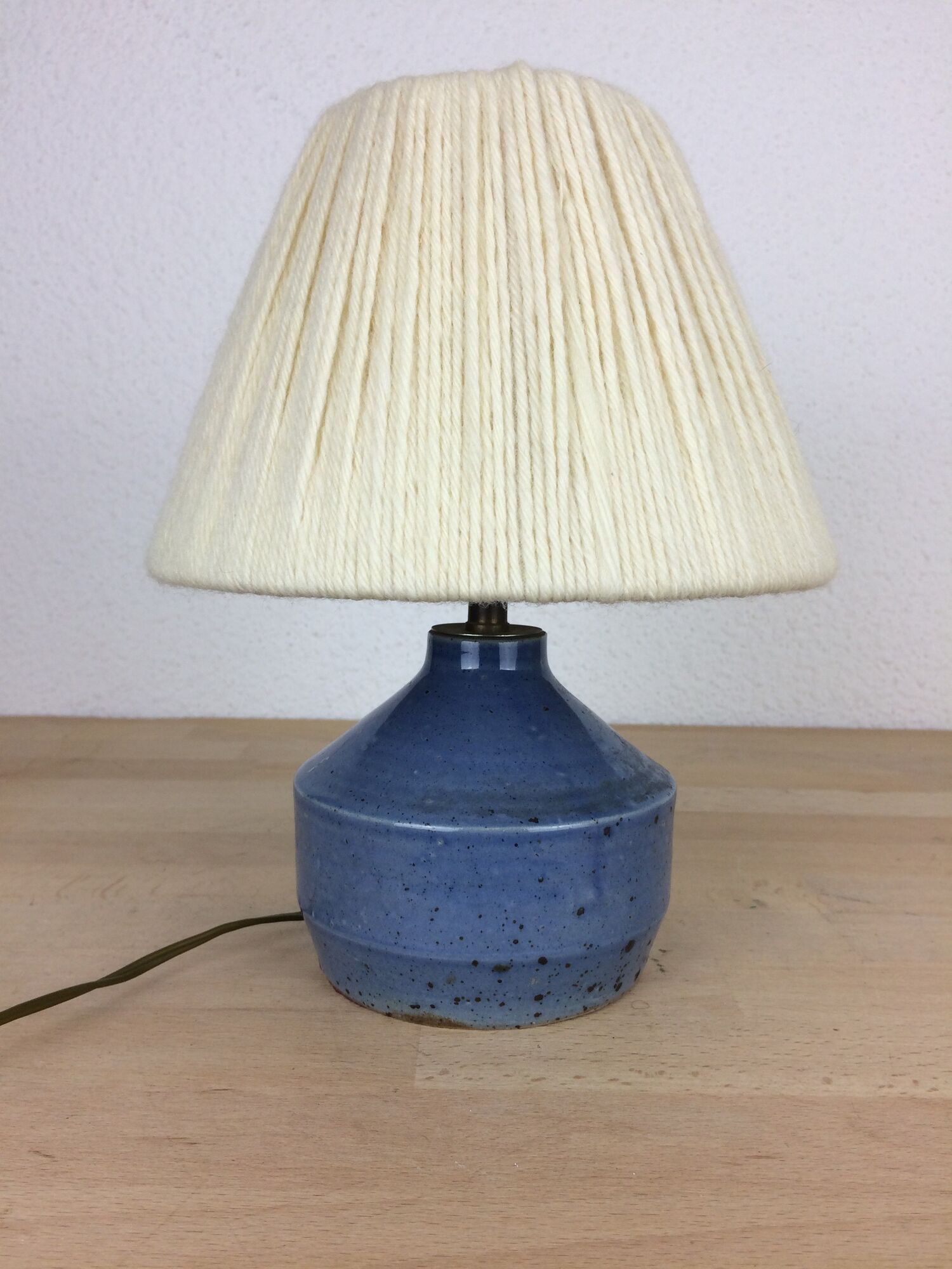 Blue ceramic lamp foot and white wool lampshade