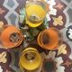 Four glasses in orange granités in orange and yellow