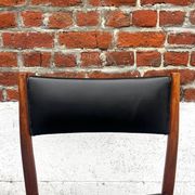 Set of 2 vintage Scandinavian chairs in wood and black faux leather.