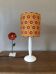 vintage white wood lamp with a seventies graphic flower shade