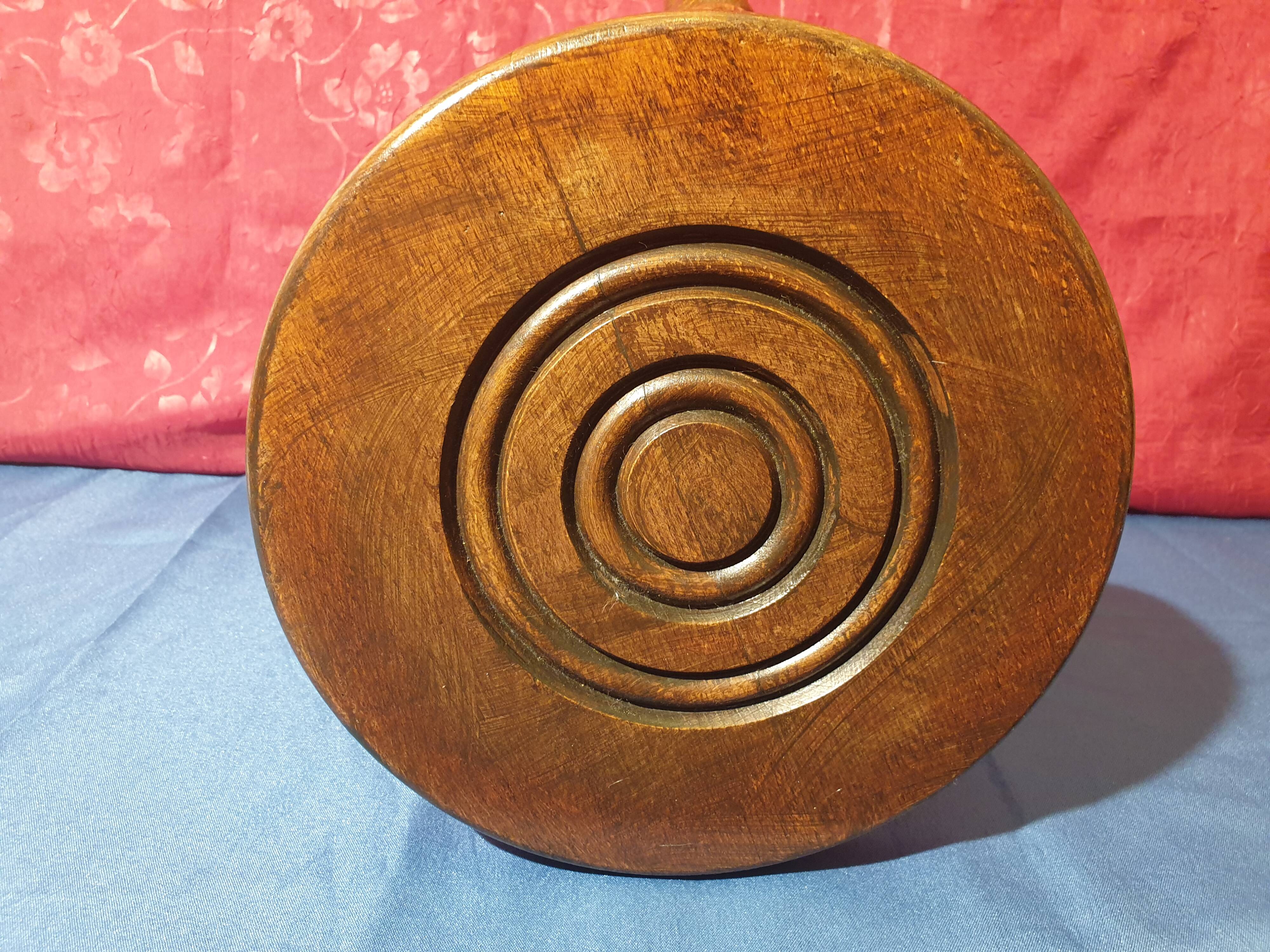 Wooden milking stool with twisted legs